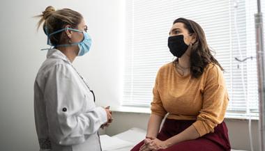 Patient and doctor discussing treatment in doctors office